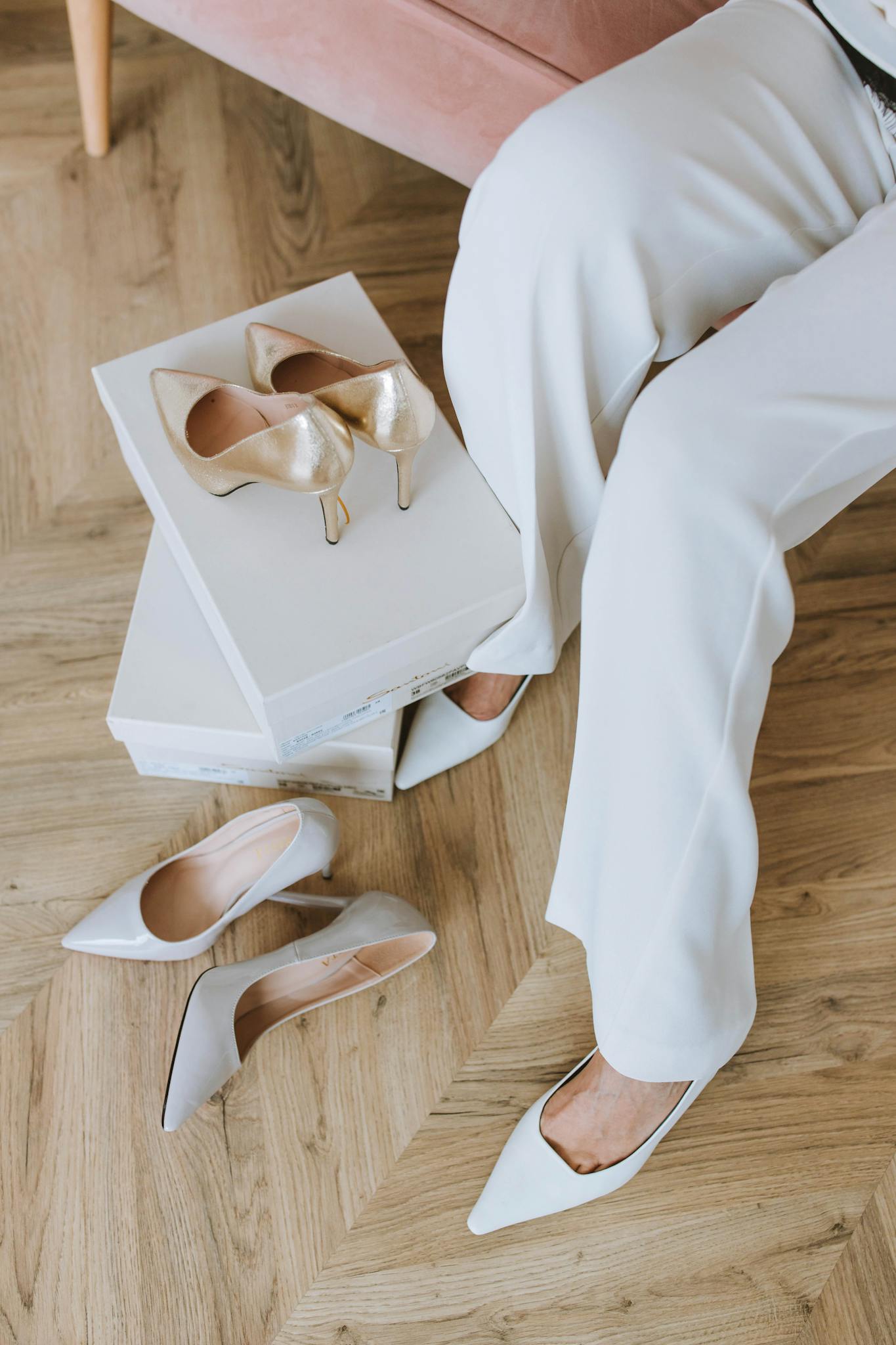 Close-up of a woman trying on elegant high heels indoors.